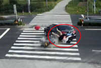 江苏一女子骑摩托车玩手机 被轿车撞飞